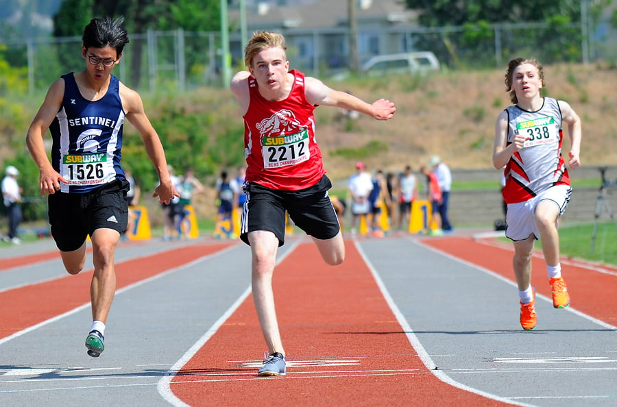 <who>Photo Credit: Lorne White/KelownaNow </who>Lynden Infanti stretches to finish first in a 100-metre preliminary heat in the Grade 8 division. Infanti finished fifth in the final and also earned gold in the long jump competition.