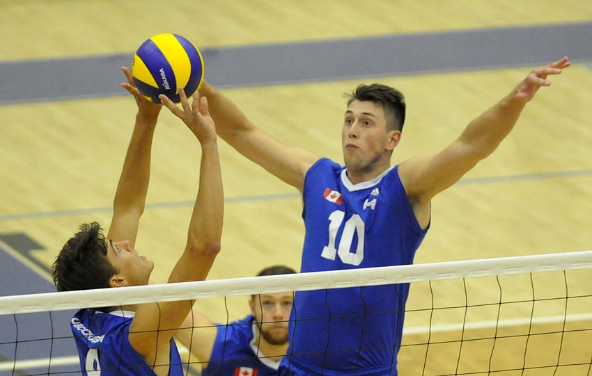 <who>Photo Credit: Lorne White/KelownaNow.com </who>Joshua Harvey of the Heat leaps to kill a set by Kristof Schlagintweit in the first set of their opening match.