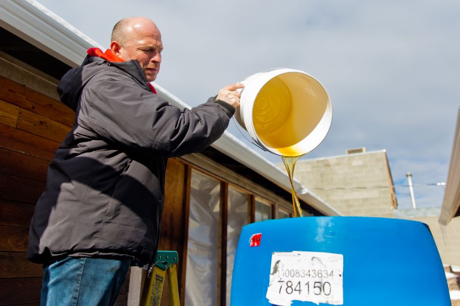 Denis Fontaine pours sap water into the barell.