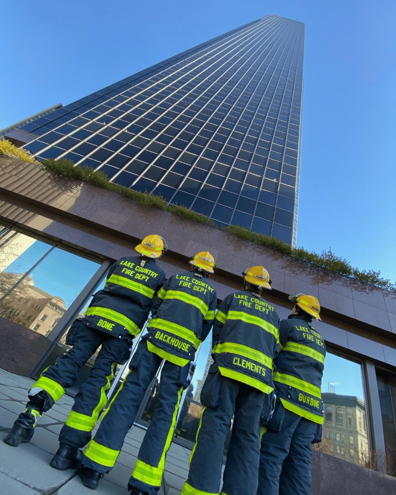 The quartet of firefighters look up at the Columbia Center, the behemoth building they had to climb.