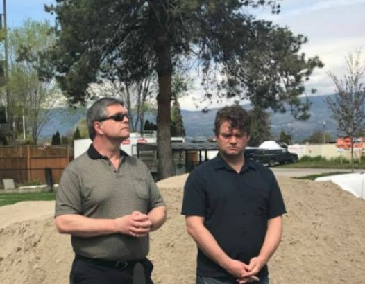 <who> Photo Credit: KelownaNow </who> Left: Shaun Reimer at media conference for flooding of the Central Okanagan.