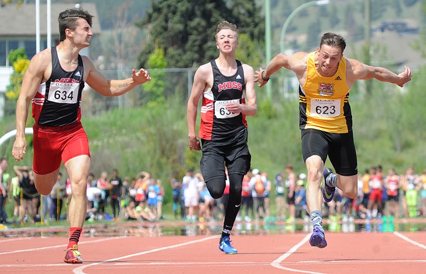 <who>Photo Credit: Lorne White/KelownaNow </who>Alex Taylor, right, of the Kelowna Owls lunges to edge Jesse Benneke, left, of the Mt. Boucherie Bears in the senior boys 100-metre sprint. Taylor's winning time was 11.24 seconds while Benneke was clocked at 11.25. In the middle is Steven Johnson, who placed fourth. Matthew Klak of the Rutland Voodoos finished third.