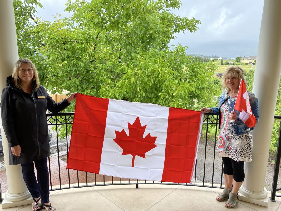 </who>The Canada Day flag promotion Kelowna-Lake Country MP Tracy Gray, left, started in 2020 will become an annual event. Gray is pictured here with Patti Dimaria, co-owner of Bella Rosa Orchards, during flag delivery in June 2020.