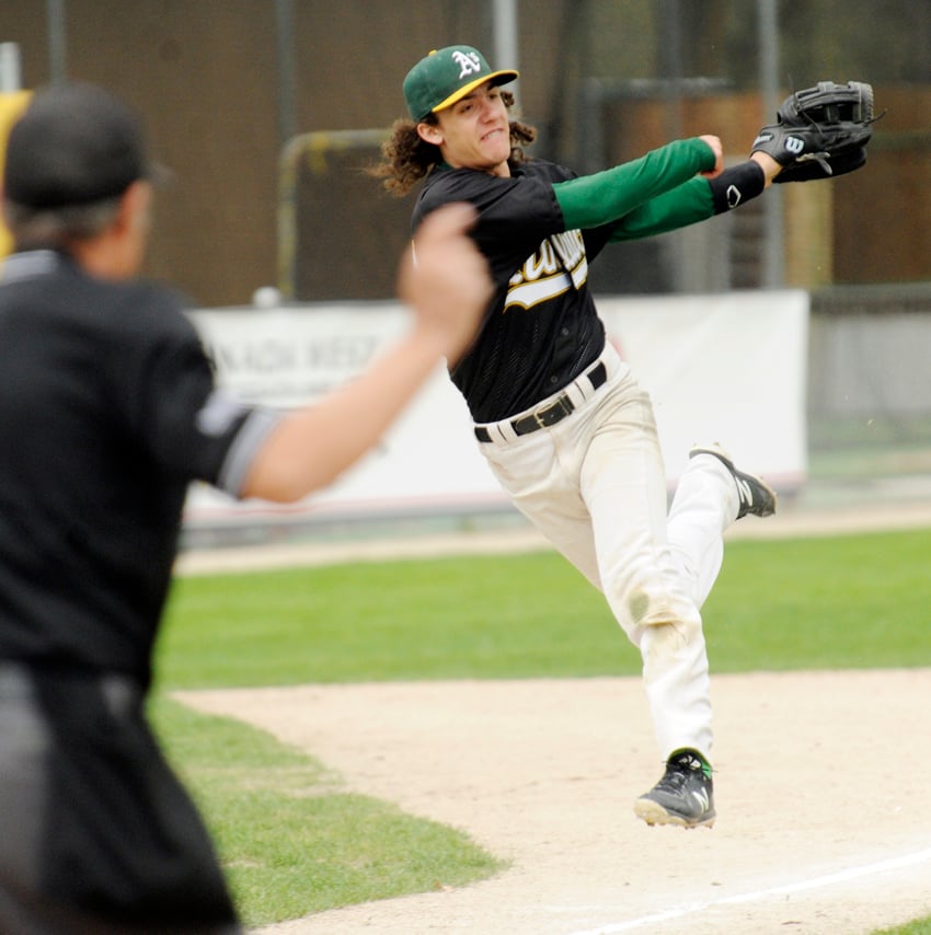 <who>Photo Credit: Lorne White/KelownaNow </who>A's third baseman Mason Glowacki follows through on a throw to first base after fielding a bunt against the Parksville Royals.