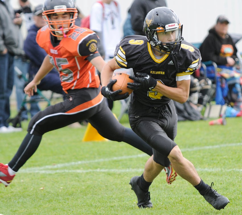 <who>Photo Credit: Lorne White/KelownaNow </who>Risto Zimmer of the Owls eludes a would-be New Westminster Hayacks tackler after making a reception and on his way to a touchdown.