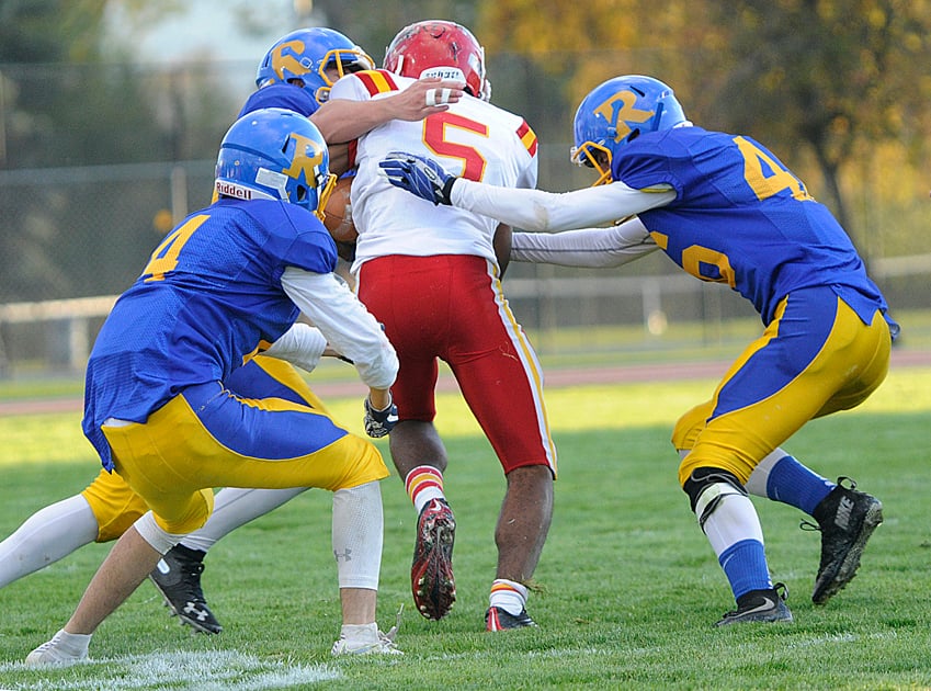Kyron Konkin, left, and Dalton Lucas of the Voodoos bring down Mouat's Nathan Hausermann.