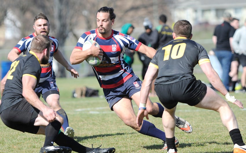 <who>Photo Credit: Lorne White/KelownaNow </who> Rick Schouten changes direction to sidestep pair of Surrey Beavers on the way to the Kelowna Crows' second try.