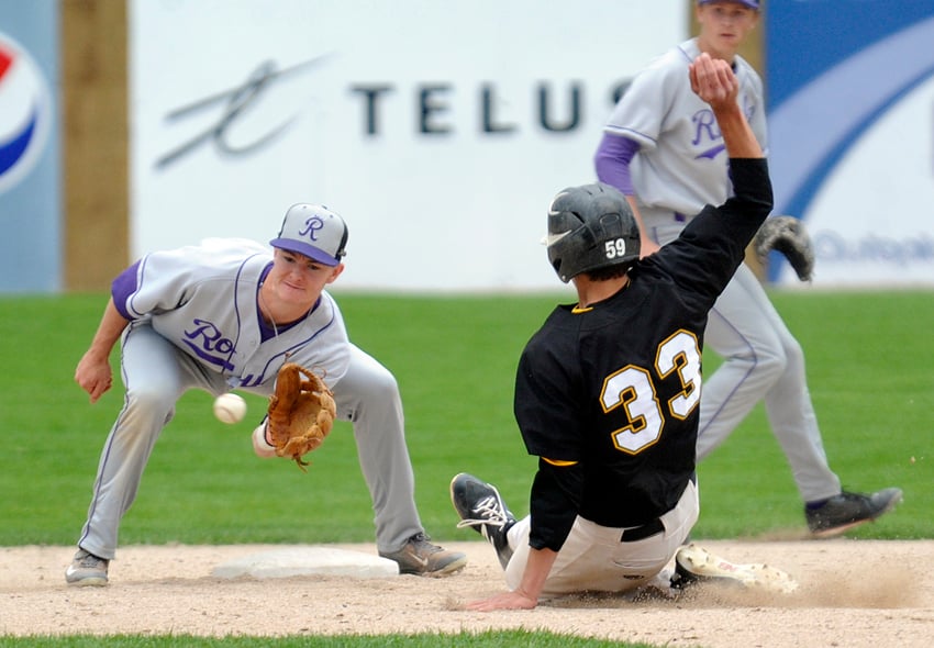 <who>Photo Credit: Lorne White/KelownaNow </who>Marcus Strother of the Athletics beats out a throw to the Royals' Thomas Green at second base.