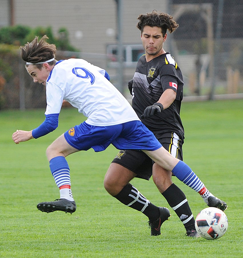 Zach McInnis of the Voodoos and the Owls' Adrian Delgado collide at midfield.