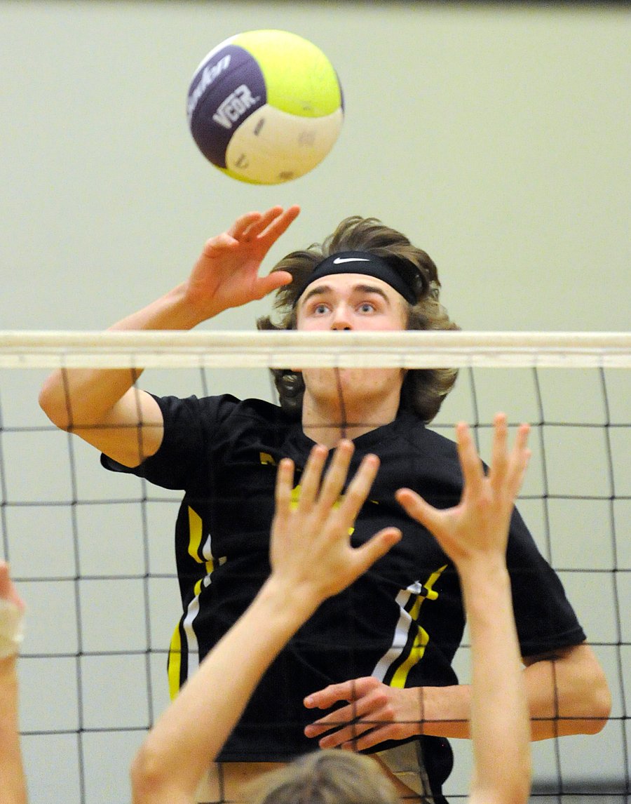 Riley Brinnen of the Owls goes high to tip at the net.