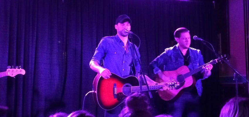 <who> Photo Credit: KelownaNow </who> Kelowna born Chad Brownlee (centre) performs at the OK Corral Friday night. 