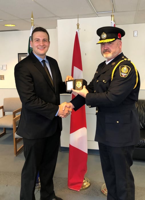 <who> Photo Credit: Nelson Police Department </who> Cst. Mathieu Nolet (L) and Chief Donovan Fisher during his Swearing-In Ceremony with the Nelson Police Department.