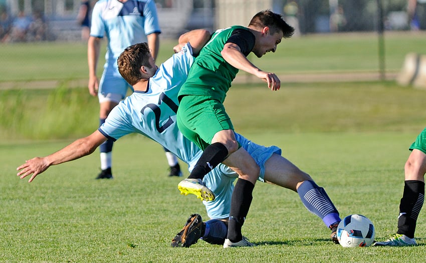 <who>Photo Credit: Lorne White/KelownaNow </who>Andrew Stevenson, left, of the Okanagan FC reaches to make contact with the ball ahead of DekSmart's Shea Ottey.