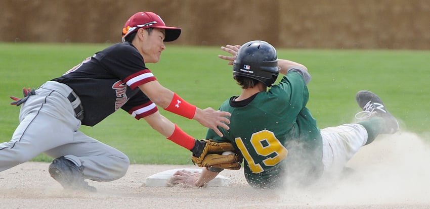 <who>Photo Credit: Lorne White/KelownaNow </who>Kade Kozak of the A's beats an Eagle tag at second base in Sunday's final encounter at Elks Stadium.