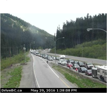 <who> Photo Credit: DriveBC </who> Traffic is backed up at the Coquihalla Summit along Highway 5. 