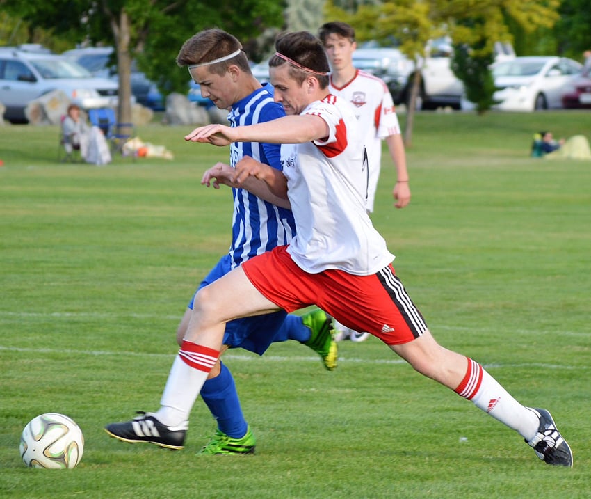 <who>Photo Credit: Contributed </who>United's Mason Chidlow, foreground, stretches to gain possession of the ball in the U18 Heat's playoff win over Vernon.