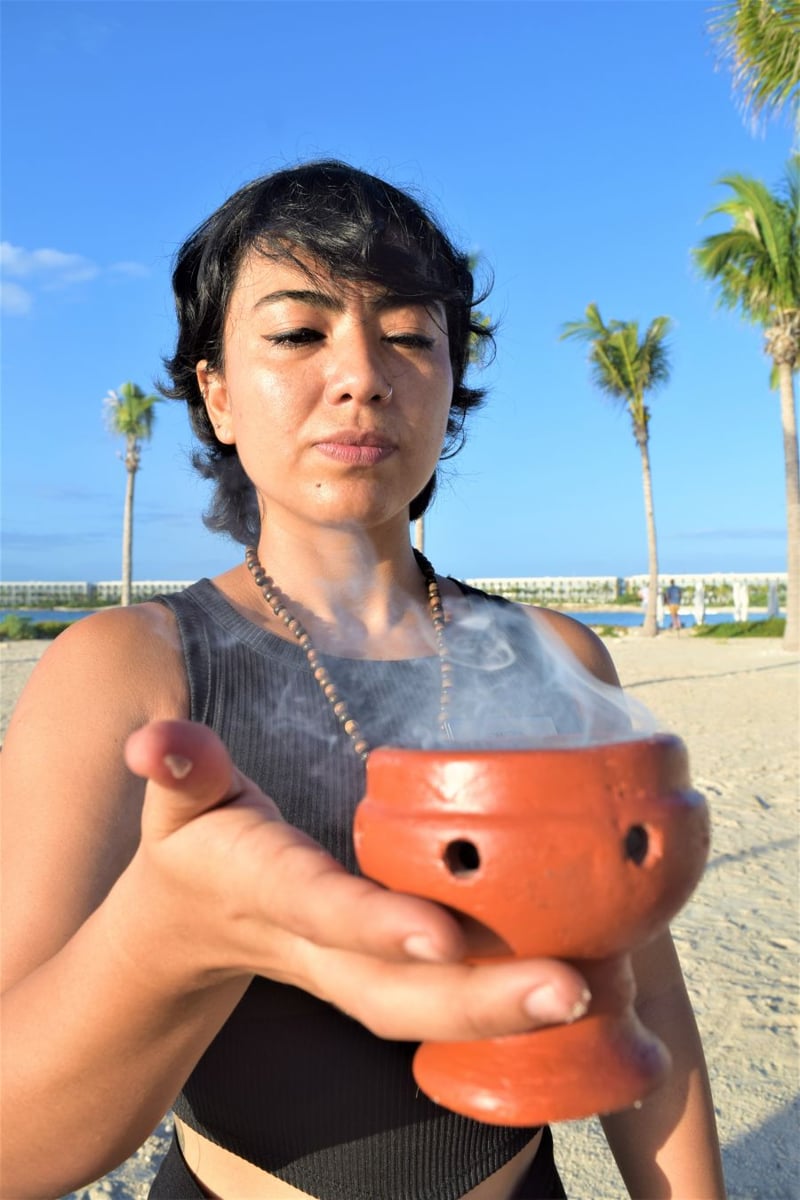</who>Yoga instructor Pamela Caceres blesses the practice with incense.