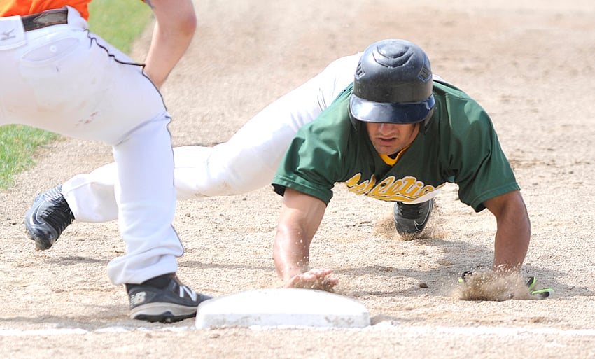 <who>Photo Credit: Lorne White/KelownaNow </who>Trevor Mlait of the A's lunges for first base on an attempted pickoff in Sunday's first of two games against Trail.