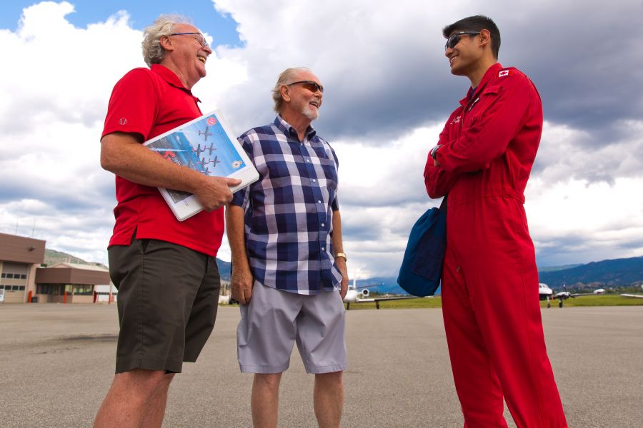 <who>Photo Credit: NowMedia</who> Captain Ari Mahajan (right) with airshow ground contact John Singleton and Snowbirds' committee chair Fred Trainor