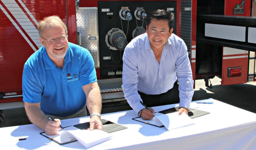 <who> Photo Credit: KelownaNow. </who> West Kelowna Mayor Doug Findlater and Westbank First Nation Chief Robert Louie signing the new agreement on Tuesday.