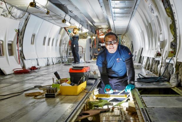 </who>KF Aerospace technicians work on a jet interior.