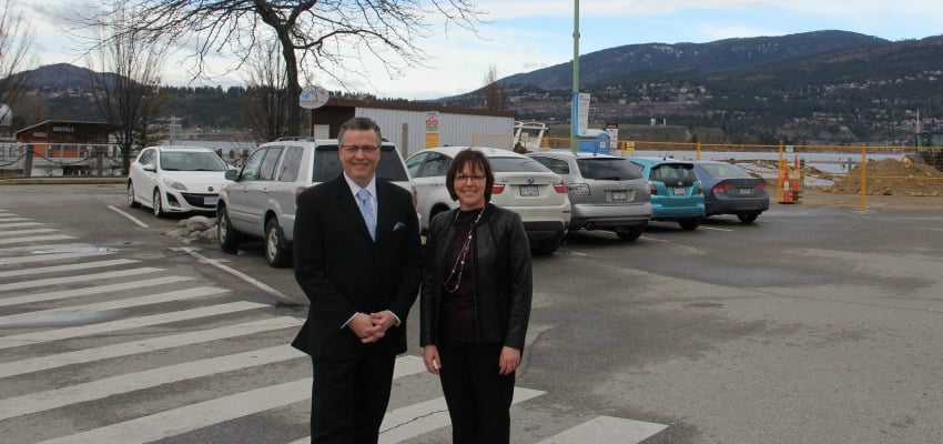 <who> Photo Credit: KelownaNow. </who> Tourism Kelowna Chair, Daniel Bibby and Tourism Kelowna CEO Nancy Cameron stand on the proposed site for the new visitor centre.