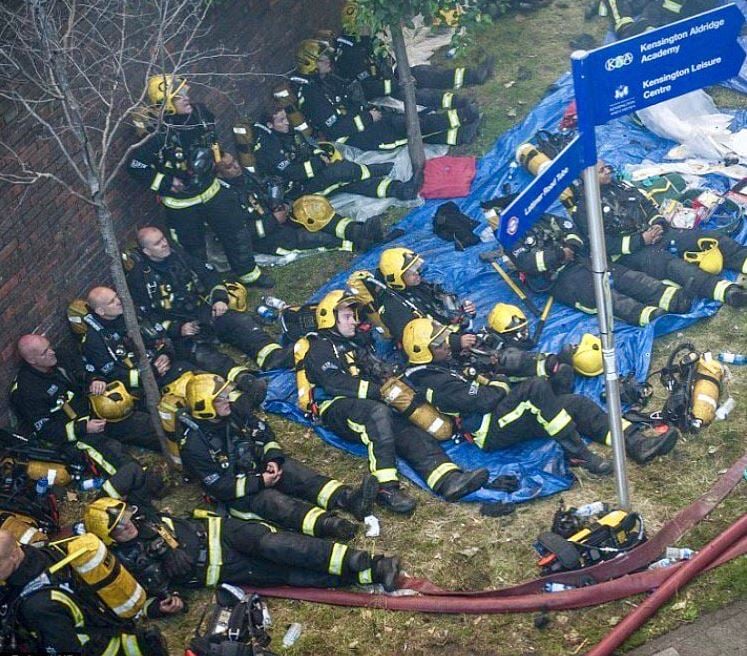 <who>Photo Credit: Twitter</who>Firefighters in London take a small break from the exhausting battle.