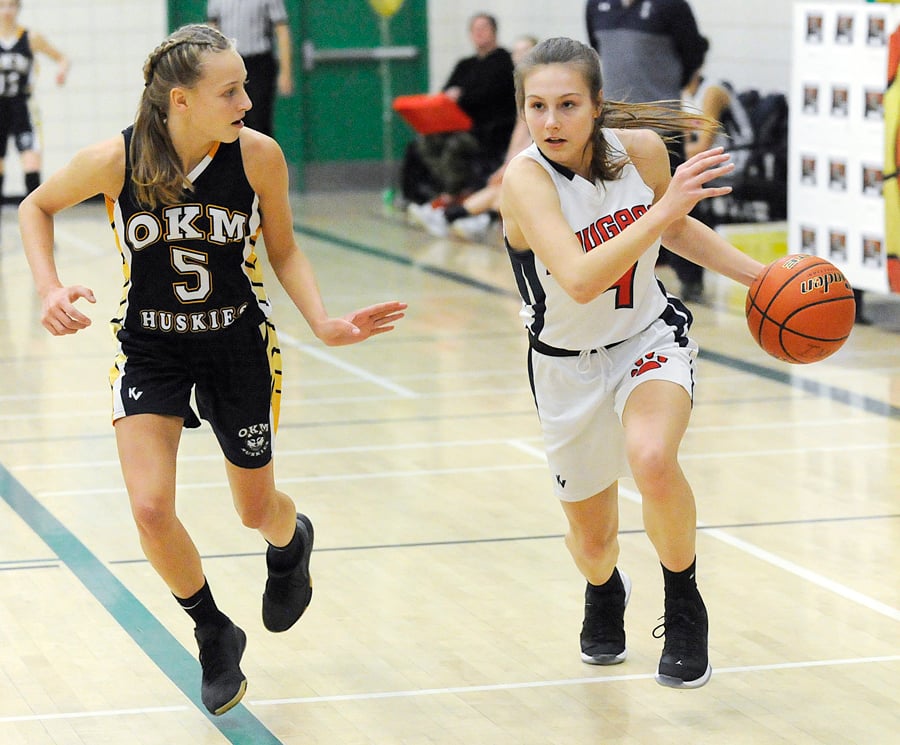 <who>Photo Credit: Lorne White/KelownaNow </who>The KLO Cougars' Denae Skelton drives to the hoop after stealing the ball from OKM's Tatum Wade. Both players were named to the tournament all-star team.