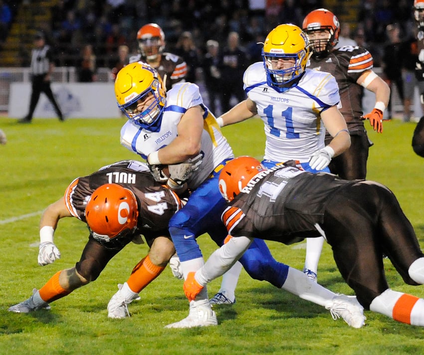 <who>Photo Credit: Lorne White/KelownaNow </who>Logan Fischer of the Saskatoon Hilltops is brought down by the Okanagan Sun's Layne hall and Conor Richard. Fischer went on to run for 105 yards on 13 carries.
