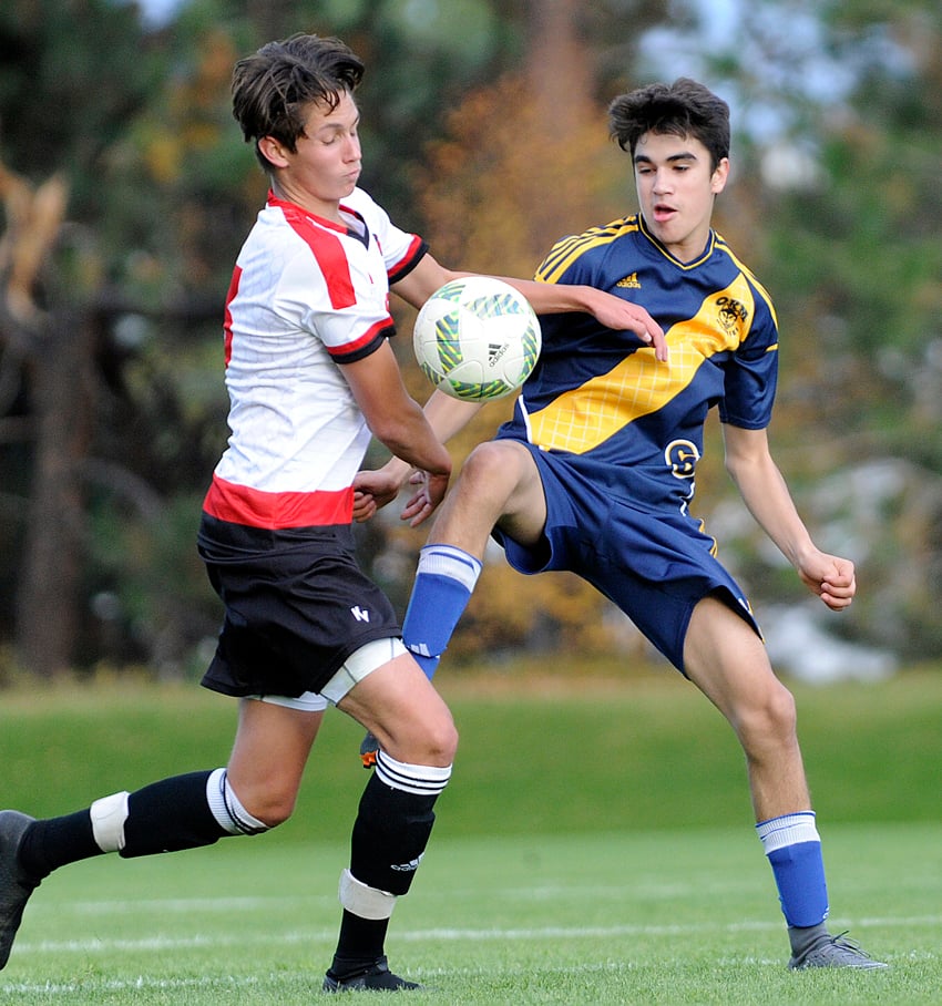 The Huskies' Brandon Nemes, right, gets a leg up on Boucherie's Attila Knaitner.