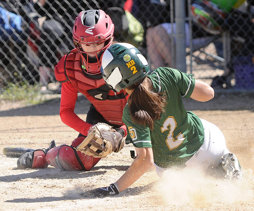 <who>Photo Credit: Lorne White/KelownaNow </who>Racquel Bennett of the Heat meets a South Delta runner at home plate, but the tag was too late as the Invader scored in a round-robin game at Kiwanis High Noon Park. It was the Heat's only loss.