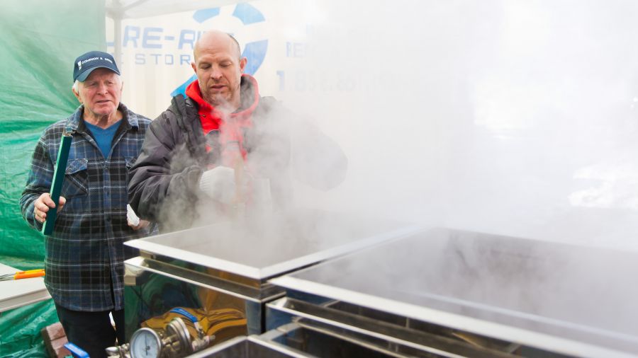 Jean-Guy Fontaie and son Denis work the boiler.