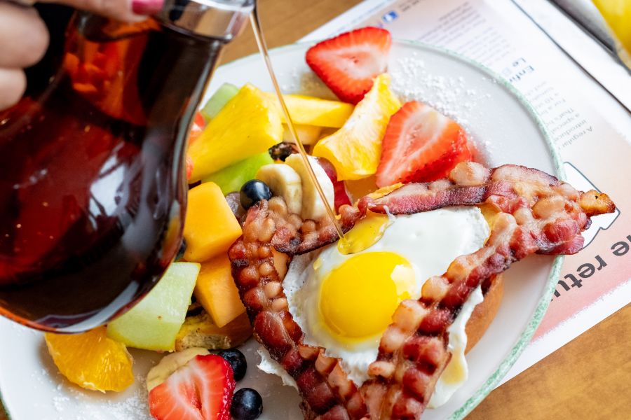 1990's harvest Brioche dipped in French toast batter and garnished with an egg, bacon and fresh fruit.