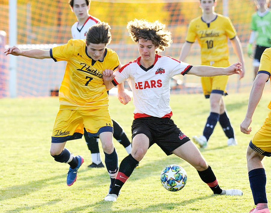 <who>Photo Credit: Lorne White/KelownaNow </who>Konstantin Pfeiffel, left, of the Huskies and Ethan Ramchuk of the Bears battle for possession.