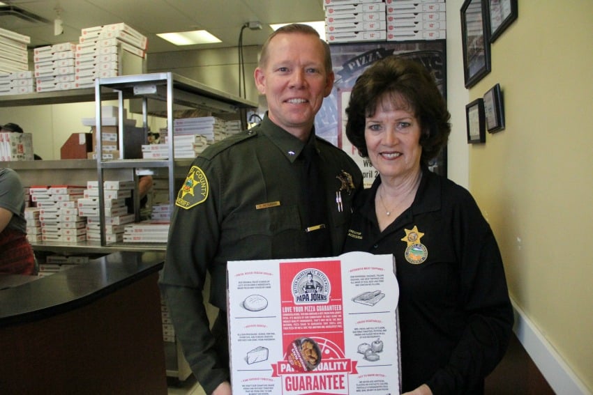 <who> Photo Credit: KelownaNow. </who> Commander Bob Peterson and Marilyn MacDougall from the Orange County Sheriff’s Department in California help look after the kids when they go to Disneyland. 