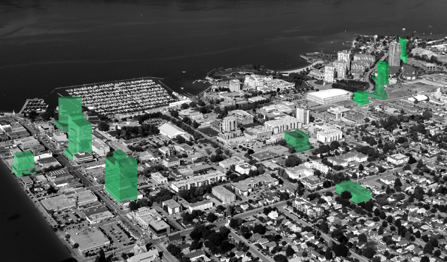 <who> Photo Credit: HM Commercial Group. </who> The photo shows Kelowna's downtown core with the proposed developments in green renderings.