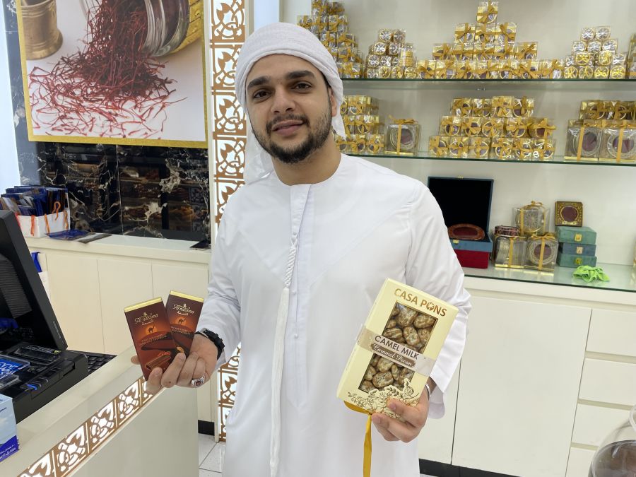 </who>Amr shows off the chocolate bars and caramel-coated pecans that are made with camel milk at Arabesq Gourmet, one of 1,200 stores at Dubai Mall.