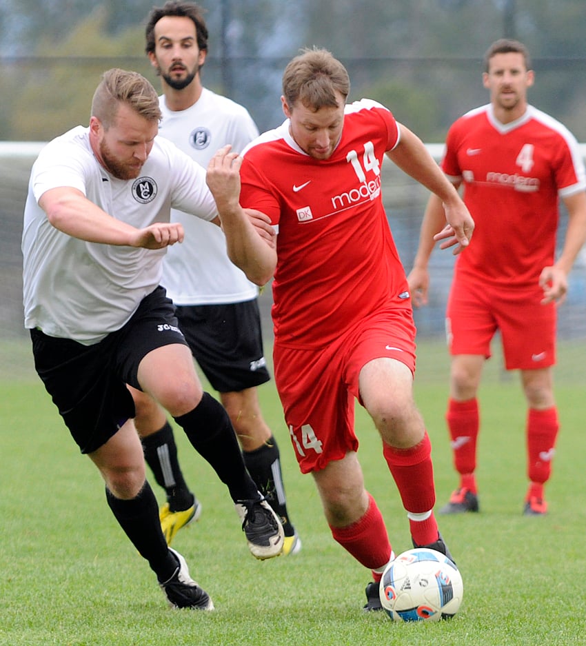 <who>Photo Credit: Lorne White/KelownaNow </who>Alain Oenema of Modern Furniture Pikeys attempts to shake Mission Cleaners' Austin Ross in the first half of their KMSL final.