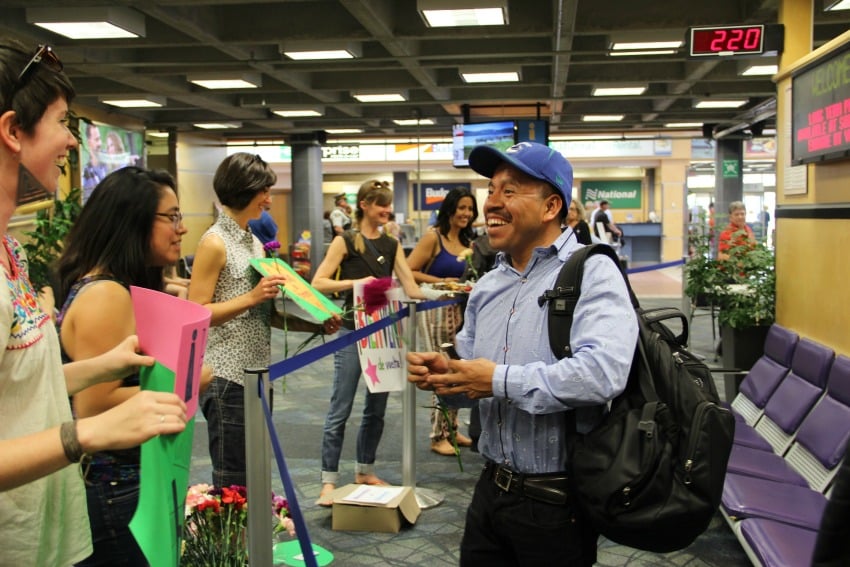 <who> Photo Credit: KelownaNow. </who> RAMA welcomes migrant workers at the Kelowna Airport on June 22. 