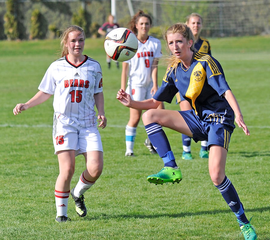 Amy Drew of OKM gets set to cradle a throw-in in front of Boucherie's Ellie Good.