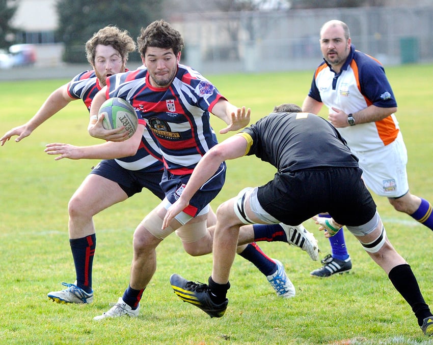 <who>Photo Credit: Lorne White/KelownaNow </who>Ignacio (Iggy) Rodriguez Guerra of the Kelowna Crows straight-arms a Surrey Beaver early in their BCRU Div. 1 match at Parkinson Sportsfields. The Crows scored seconds later, but ended up dropping a 45-15 decision.