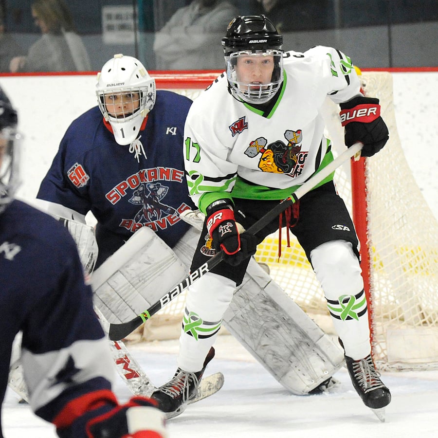 Marshall Porteous of the Chiefs makes his presence felt in front of Braves' goaltender Marcello De Antunano.