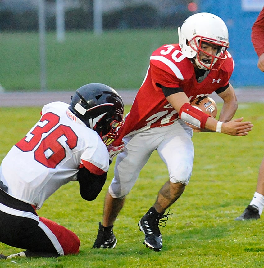 Abbotsford's Calum Rowsell gets a piece of Boucherie running back Juan Jose Hernandez Ruiz.