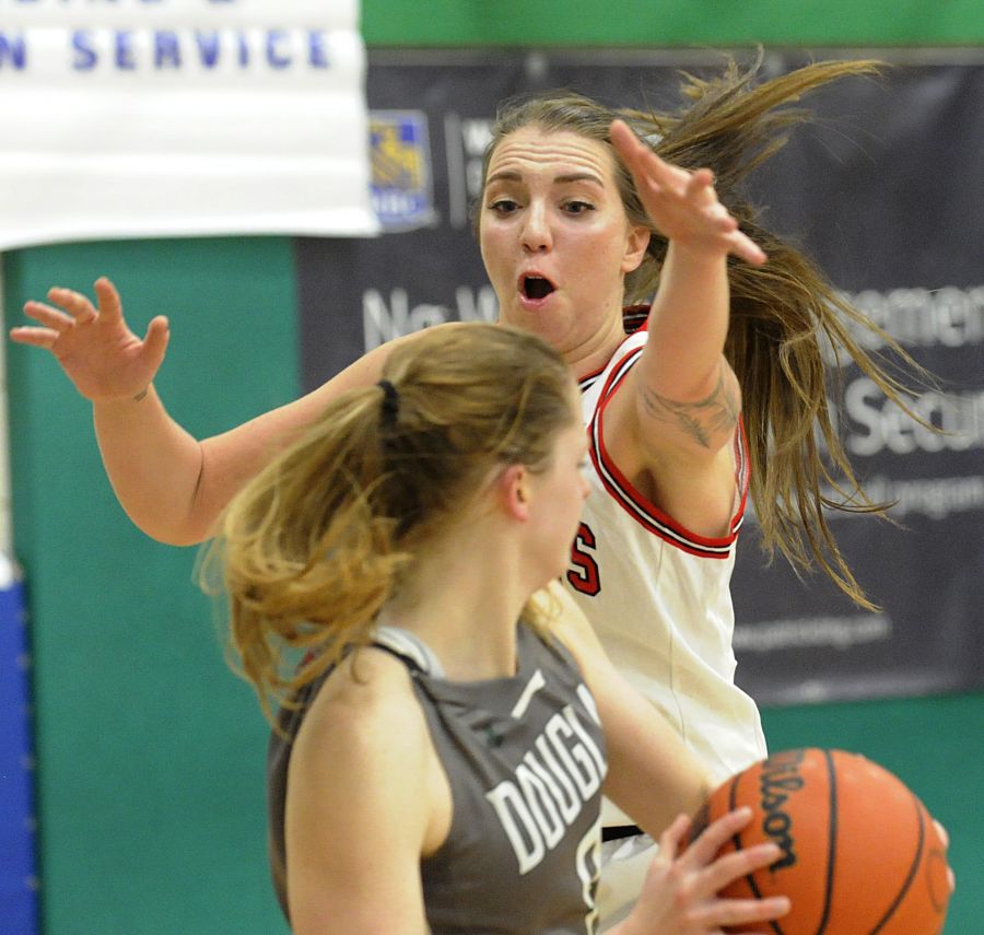 <who>Photo Credit: Lorne White/KelownaNow </who>The Coyotes' Ciara Bamford up close and personal under the Douglas Royals' basket.