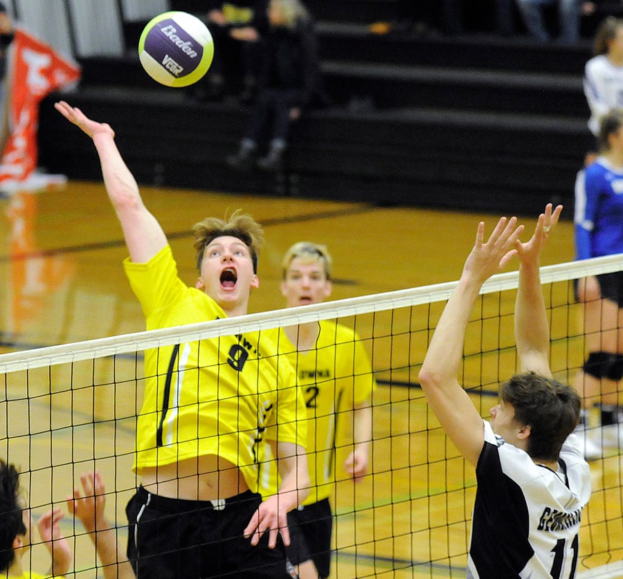 <who>Photo Credit: Lorne White/KelownaNow </who>The Owls' Max McDonald goes for spike in the middle in quarter-final play against GESS.