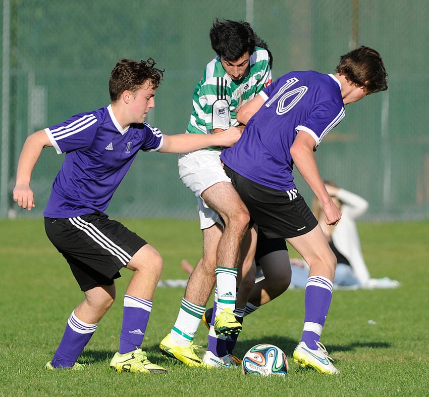 <who>Photo Credit: Lorne White/KelownaNow </who>KCS Knights' Jean de Villiers, left, and Sean Klassen, right, defend against Immaculata's Lucas Monz.