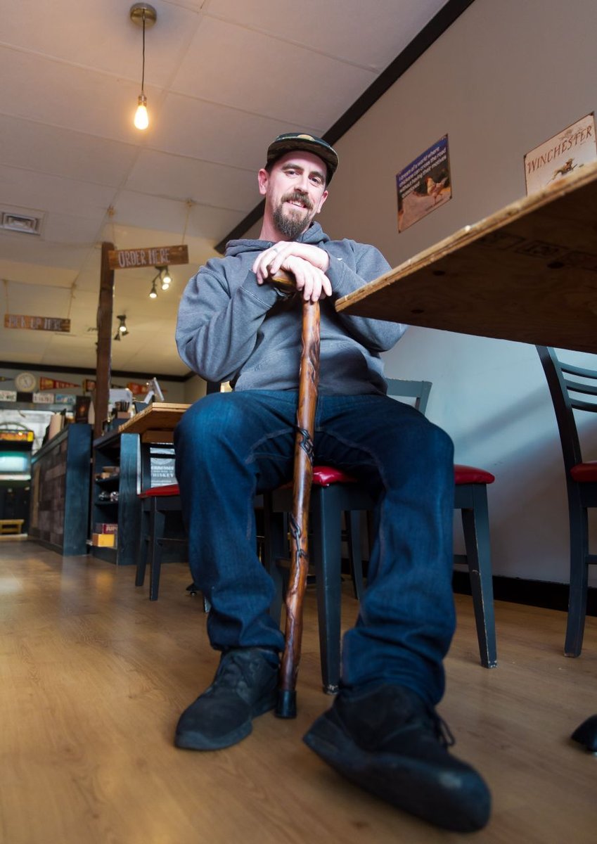 <who>Photo Credit: NowMedia</who> Josh Shulman, with his new hand-carved cane, takes a break in his restaurant