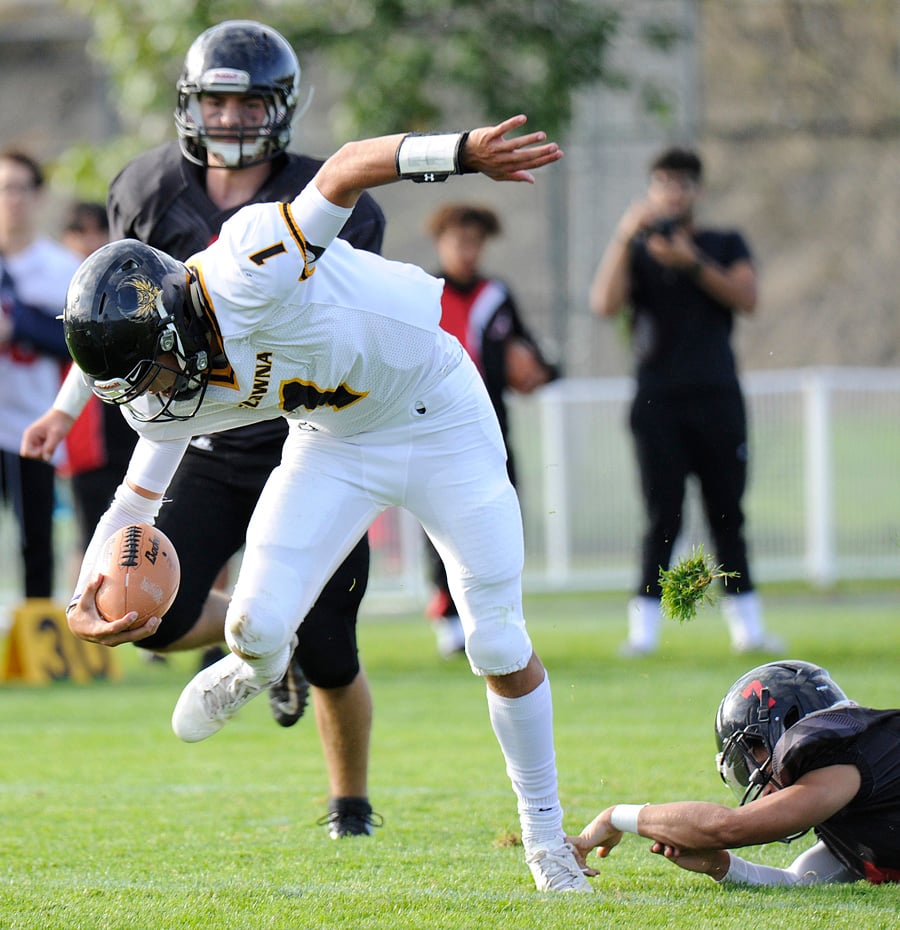 <who>Photo Credit: Lorne White/KelownaNow </who>Owls' QB Isaac Athans threw for 118 yards but didn't find much room along the ground against Abby.