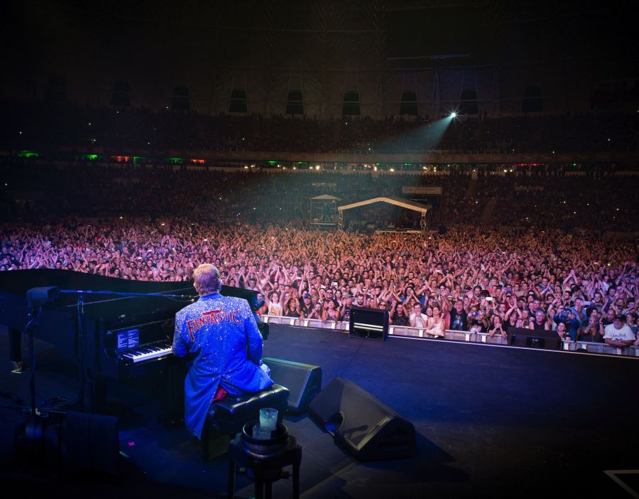 <who>Photo Credit: Facebook</who>Elton John salutes the crowd at a show earlier this month.