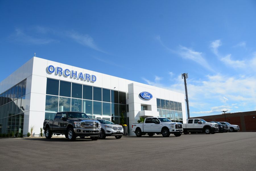 <who> Photo Credit: KelownaNow </who> As an American company, Canadian Ford factories that supply our dealership would face rising pressure to relocate to the USA which would increase the price of cars sold at our dealership. 